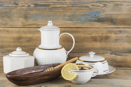 Cup of tea with lemon and honey on wooden backgroundの写真素材