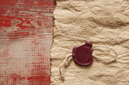 blank old paper with a wax seal on wooden backgroundの写真素材