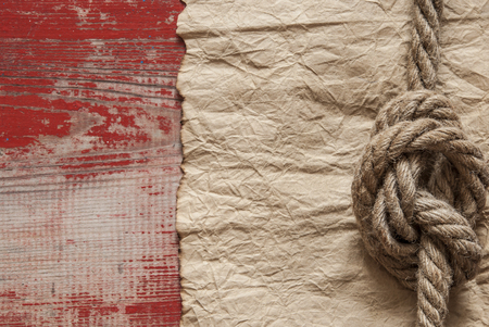 Nautical background with old paper or parchment or map and a rope with a sailor's knotの写真素材