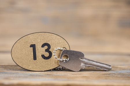 A key of the number 13 room on wooden tableの写真素材