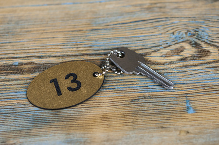 A key of the number 13 room on wooden tableの写真素材