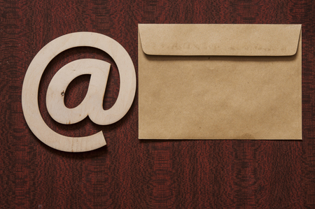 sign e-mail, paper letters on a wooden background table. Internet, correspondence.の写真素材