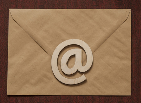 sign e-mail, paper letters on a wooden background table. Internet, correspondence.の写真素材