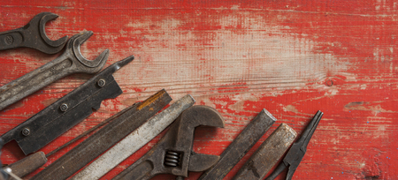 Different repair vintage tools and equipment border on wood background with copy space, top view