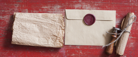 Old envelopes with red sealing wax and old thin rope a on wood textureの写真素材