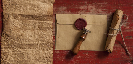 Old envelopes with red sealing wax and old thin rope a on wood textureの写真素材