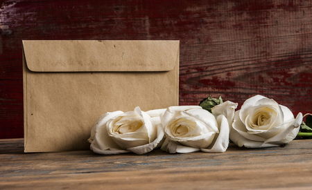 White roses on a old wooden tableの写真素材