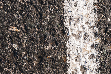 Surface rough and wet of asphalt after the rain, Grey with white line on the road and small rock, Texture Background,の写真素材
