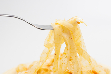 Glass noodle salad (Funchoza) with fork on white backgroundの写真素材