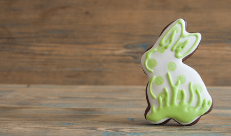 Colorful Easter cookies all over wooden background. Top view.