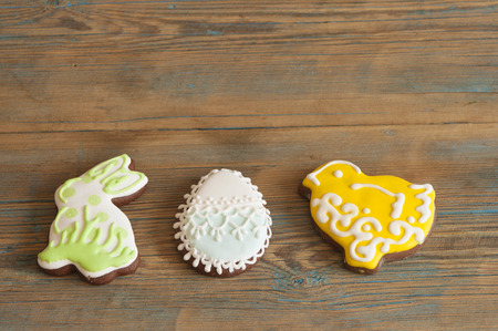 Colorful Easter cookies all over wooden background. Top view.