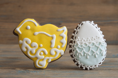 Colorful Easter cookies over wooden background. Top view.