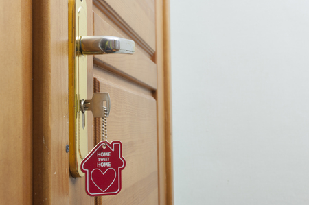 A key in a lock with house icon on it の写真素材