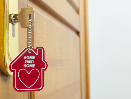 A key in a lock with house icon on it の写真素材
