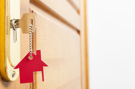 A key in a lock with house icon on it 