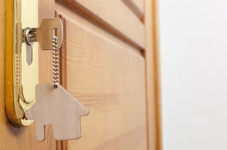 A key in a lock with house icon on itの写真素材