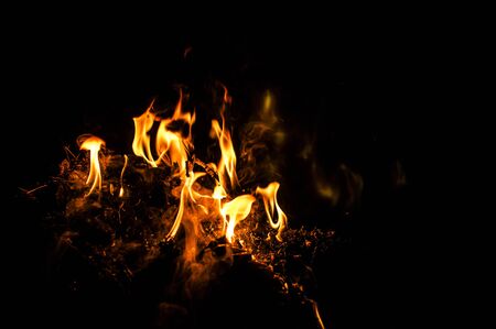 red flames of fire over black backgorundの写真素材