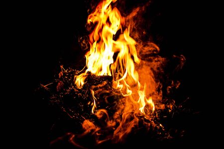 red flames of fire over black backgorundの写真素材