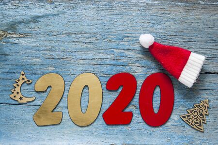 New year concept - Number 2020 for New Year and decoration on a wooden table. With vintage styled...
