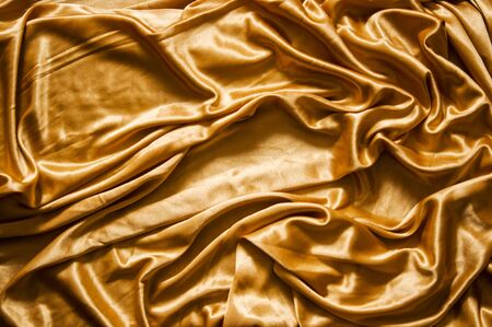 Gold silk texture of satin abstract background.の写真素材
