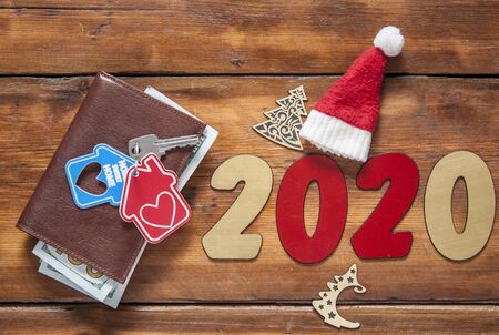 Key home and leather wallet on old wooden table. Christmas backgroundの写真素材