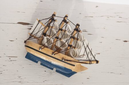 Ship model on a white wooden background