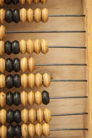 Old wooden abacus on a wood background. Calculating frame. Old scores or calculator.