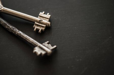 Bunch of old keys on dark wooden background, close up