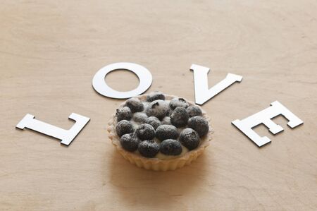 The fruit cupcake with the word love on a white background. Copy spaceの写真素材