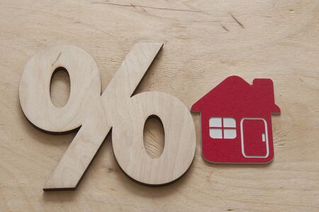 Percentage and house sign symbol icon wooden on wood table