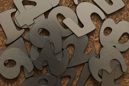 Scattered silver numbers on the table for mathematics concept 