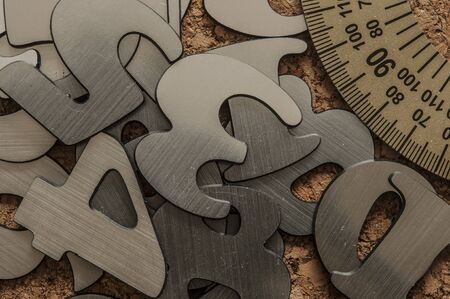 Scattered silver numbers on the table for mathematics concept の写真素材