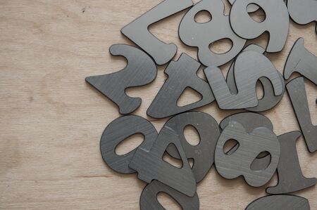 Scattered silver numbers on the table for mathematics concept 