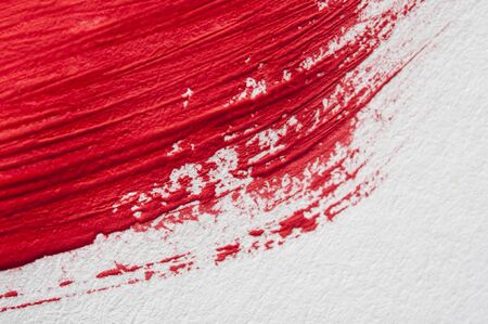 watercolor red brush stroke on white paper backgroundの写真素材