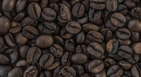 Brown coffee beans, close-up of coffee beans for background and texture