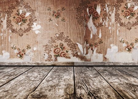 old grunge room, wooden floor, wall background with torn vintage wallpaper. retro backgroundの写真素材