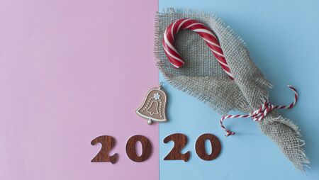 Colorful candy lollipops Christmas candy on blue and pink  background. 2020 Happy new year