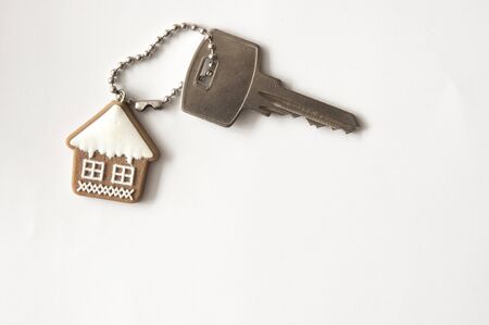 Silver key and house shaped keychain with copy space for text.