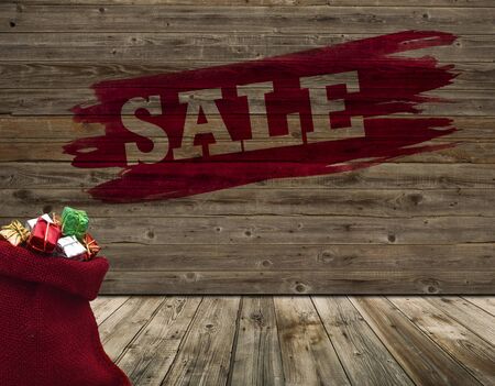 Wide wooden wall with word sale and red sack in old roomの写真素材