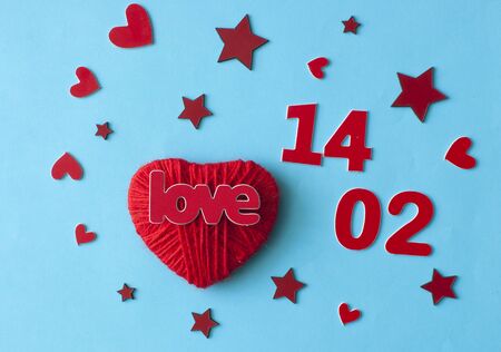 Love word, heart and stars on soft blue paper  background. Top view. Valentines day, holiday.の写真素材