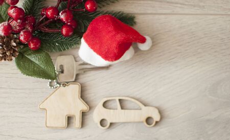 Beautiful Christmas background: decorative house and key to the lock with Santa hat. Concept of finance and housing loans. Top viewの写真素材