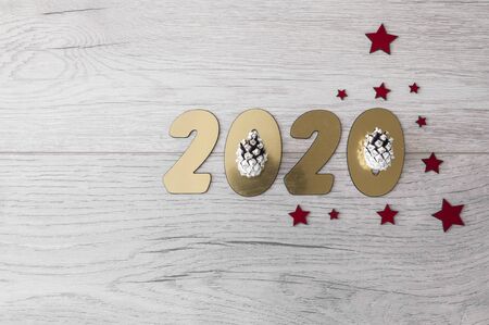 New Year's composition. Christmas tree branches with berries on a wooden background.  New 2020 year...