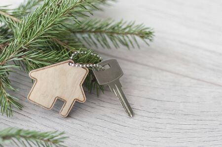 Beautiful Christmas background: decorative house and key to the lock. Concept of finance and housing...