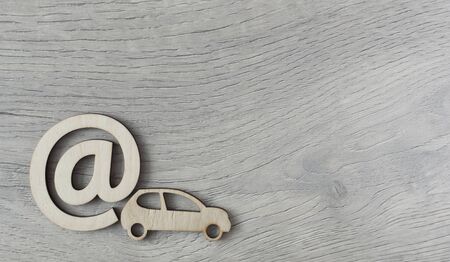Car toy and email sign on white wood background minimal creative concept. Space for copy.の写真素材