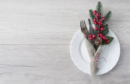 Christmas table place setting on wooden background, top view with copy space. Holidays backgroundの写真素材