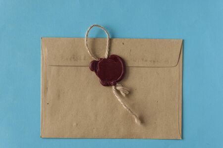sealed brown envelope on blue backgroundの写真素材