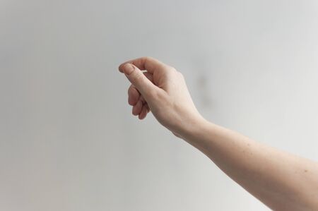 Woman hand throwing paper plane over white background