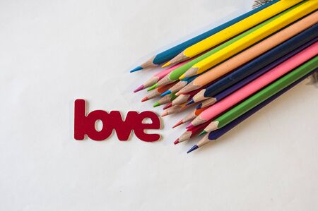 Love Mother's day and Valentine 's day concept, word "love" on white paper with colorful pencilsの写真素材