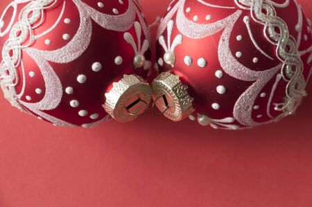 Red Christmas baubles decoration on red background with copy space. New Year greeting card. Minimal style. Flat lay.の写真素材
