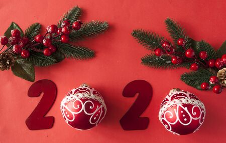 2020 New year concept. 2020 number and Festive decorations, Christmas red balls on paper background. Creative New year holiday background. Flat lay. Copy spaceの写真素材